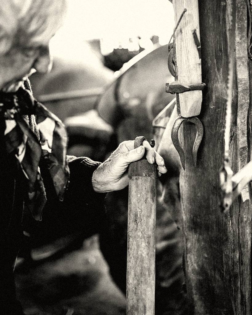 A craftsman shaping a piece of wood by hand.
